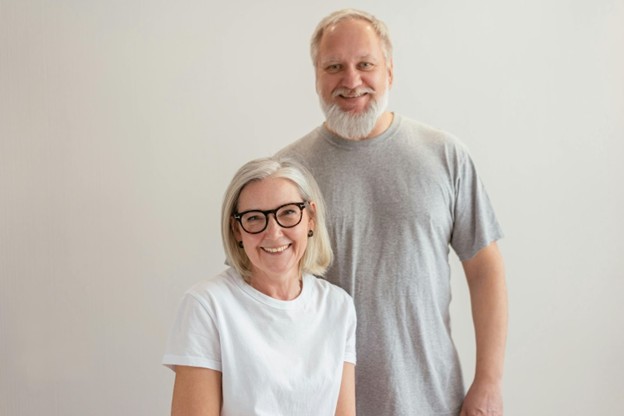 Smiling older couple standing together after Peptide Therapy